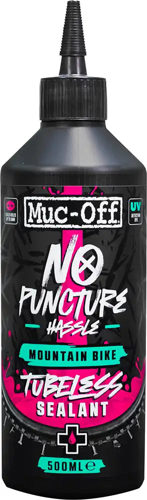 Muc-Off No Puncture MTB Tubeless Sealant bottle, mountain bike accessories with orange and black packaging, close-up view.
