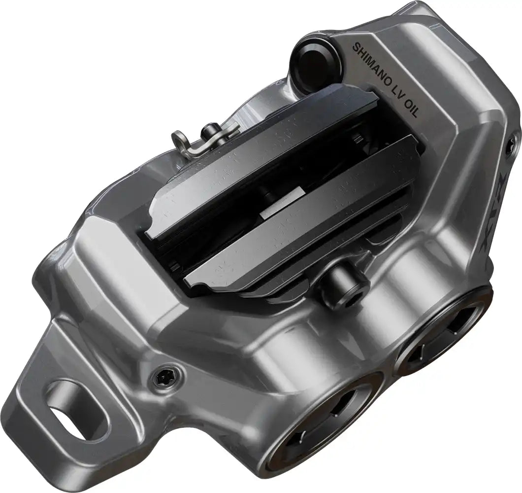 Shimano XTR Enduro M9220 hydraulic disc brake caliper for mountain biking, shown in a close-up view of the black brake part.