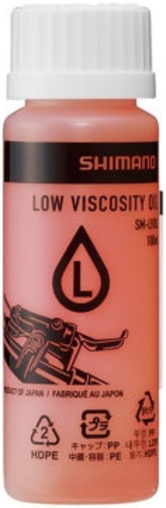 Shimano low viscosity mineral oil bottle for bike parts, with a clear label and white cap, on a plain background.