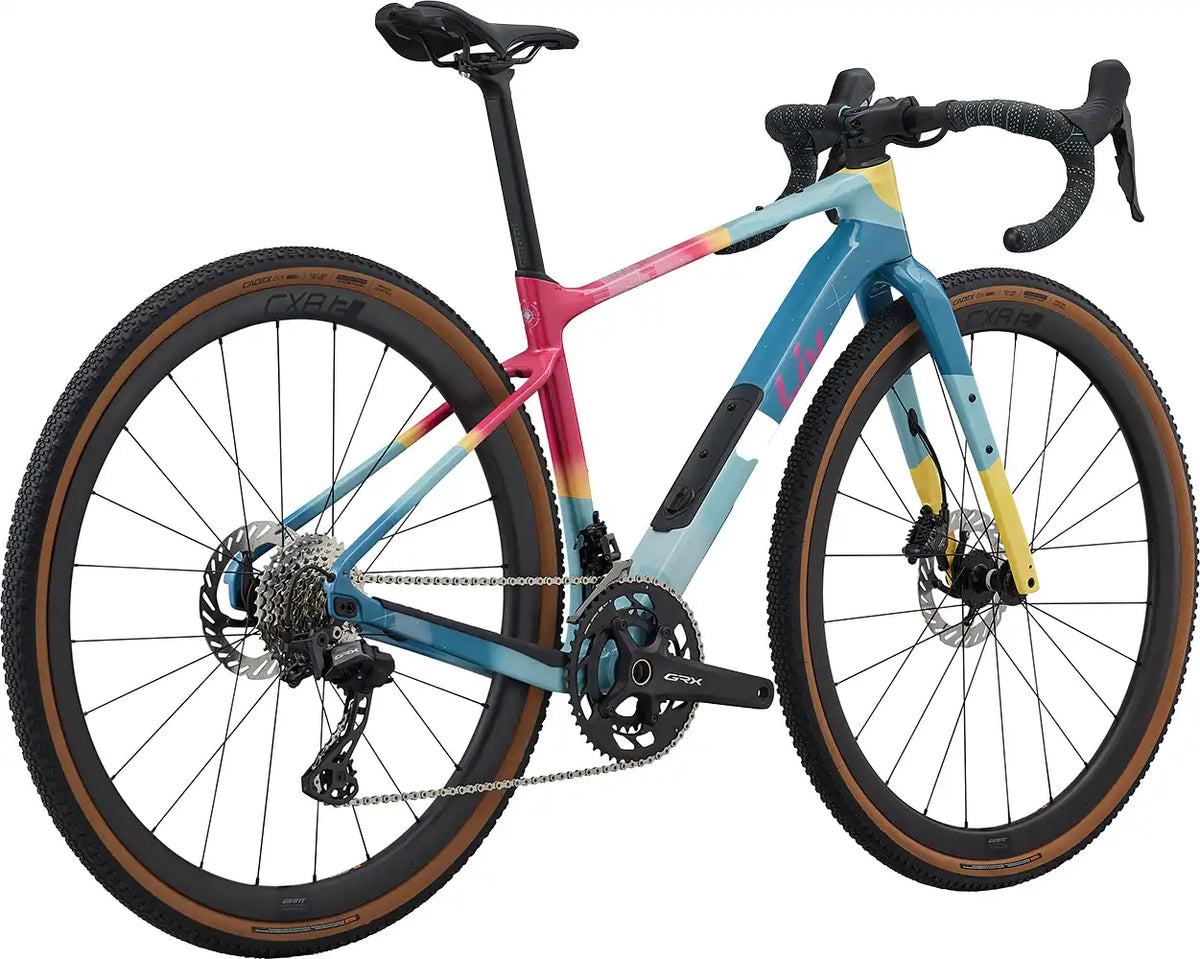 Liv Devote Advanced 0 SE gravel bike in vibrant color, rear view showing lightweight frame and rugged tires for off-road riding