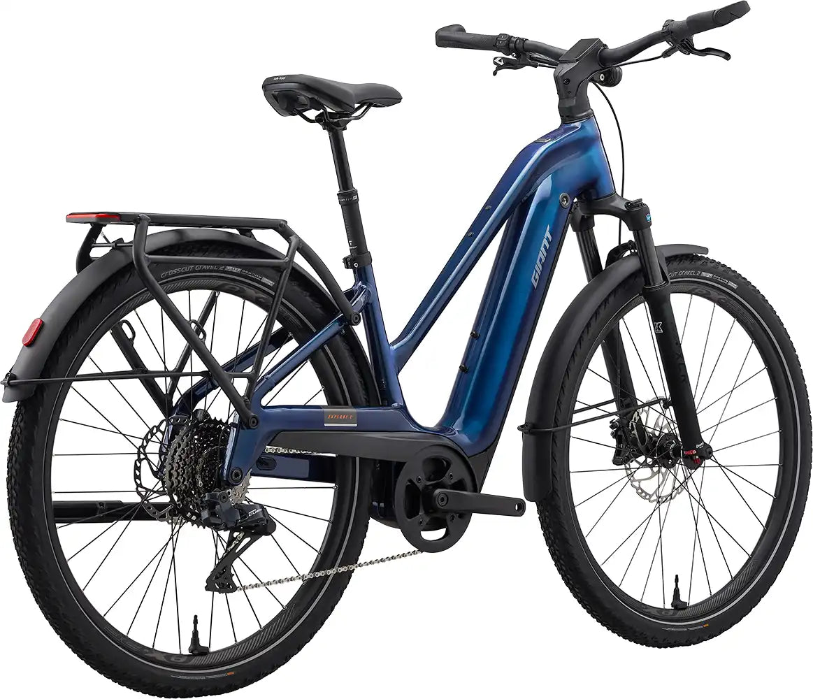 Giant Explore E+ 1 electric bike in metallic navy, shown from the rear, featuring a sturdy frame and rear wheel.
