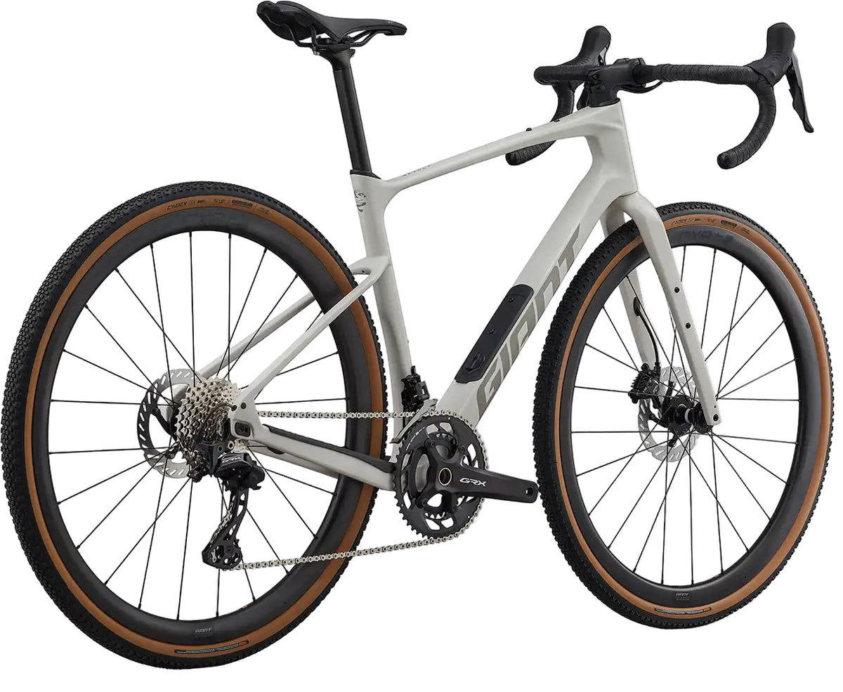 Giant Revolt Advanced 0 gravel bike in Snow Drift color, rear view showing lightweight frame and off-road tires.