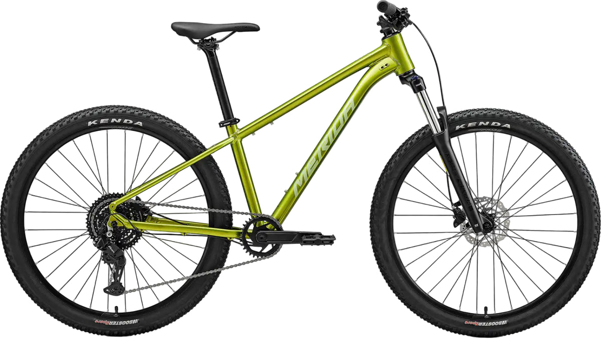 Merida Big Seven 20 hardtail mountain bike in fall green and silver, featuring a lightweight frame and off-road tires.