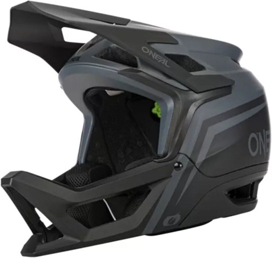 Oneal Transition full face helmet with black and white design, featuring vents and secure strap for motorcycle or motocross riding.