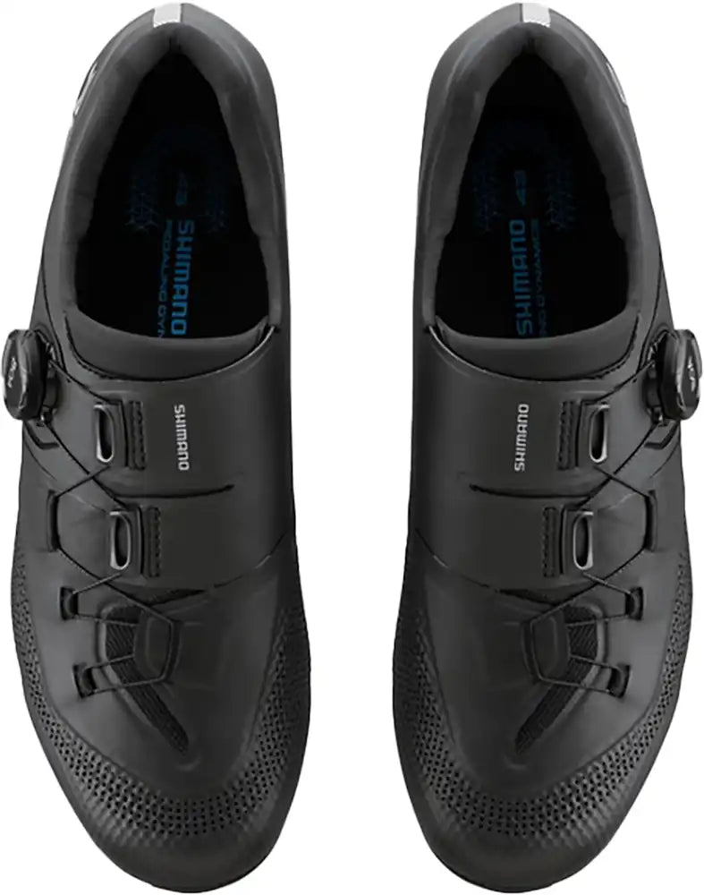 Shimano RC503 men's road cycling shoes with black and white design, featuring Velcro straps and breathable mesh uppers.