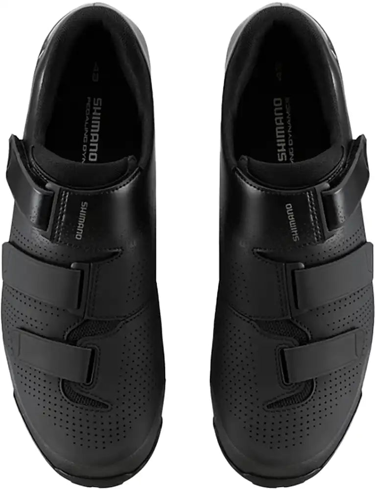 Shimano XC102 men's MTB shoes in black with white accents, featuring durable sole and secure strap closures.