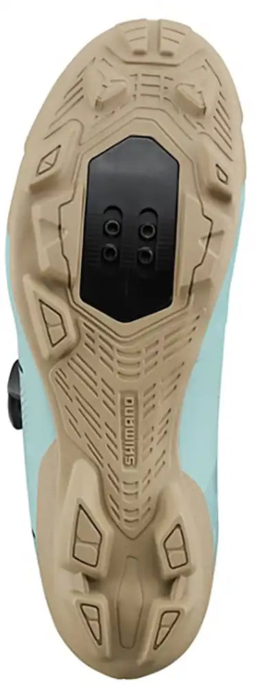 Shimano XC302 women's mountain biking shoes showing black and pink design with rugged soles and secure straps.
