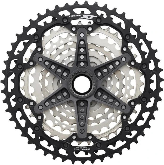 Shimano XT M8100 12-speed cassette with 10-51T sprockets, shown mounted on a bike drivetrain component.