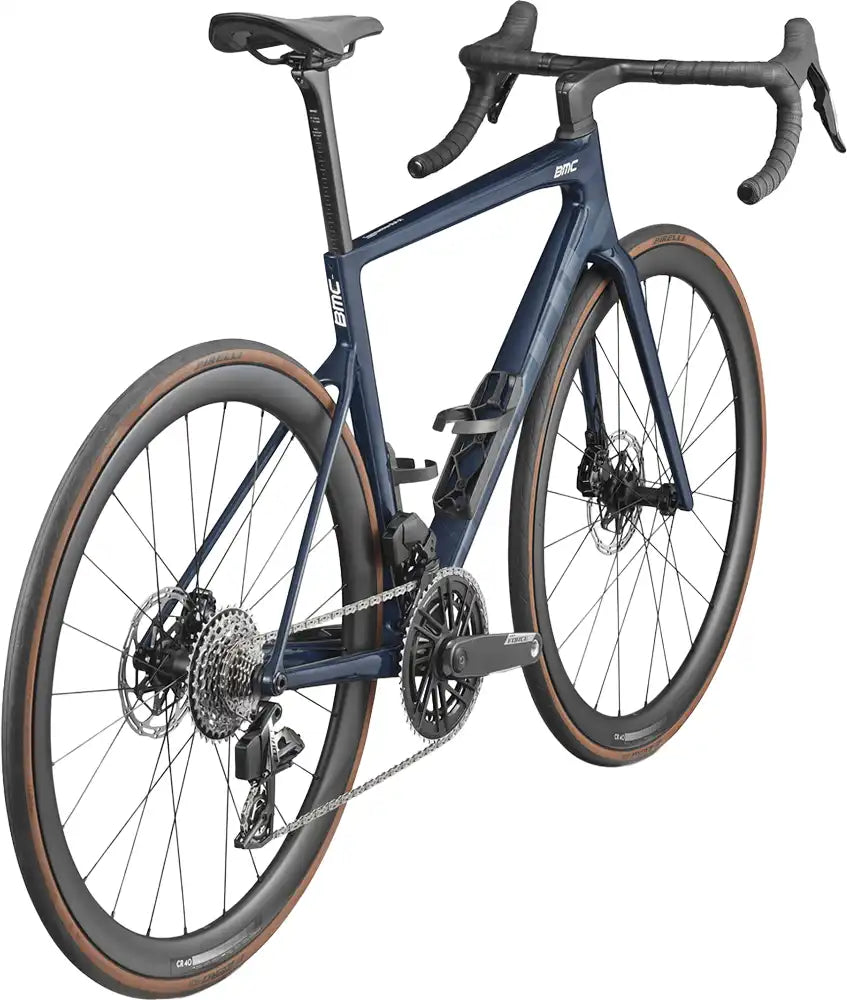 BMC Teammachine SLR 01 FIVE road bike with sleek frame, drop handlebars, and racing tires in a dynamic riding position