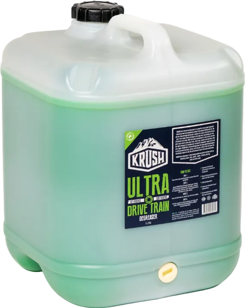 Krush Ultra Drivetrain Degreaser bottle, accessory for cleaning bike chains and gears, with clear label and spray nozzle visible.
