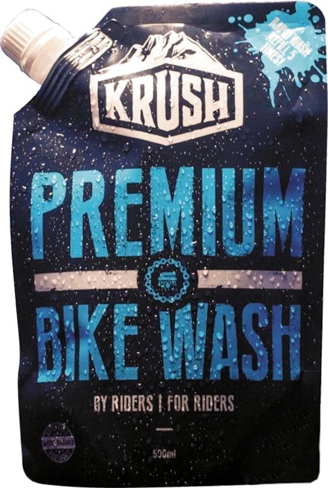 Krush Premium Bike Wash accessories, showing a bottle of bike cleaner with a spray nozzle and cleaning accessories for bicycle maintenance.